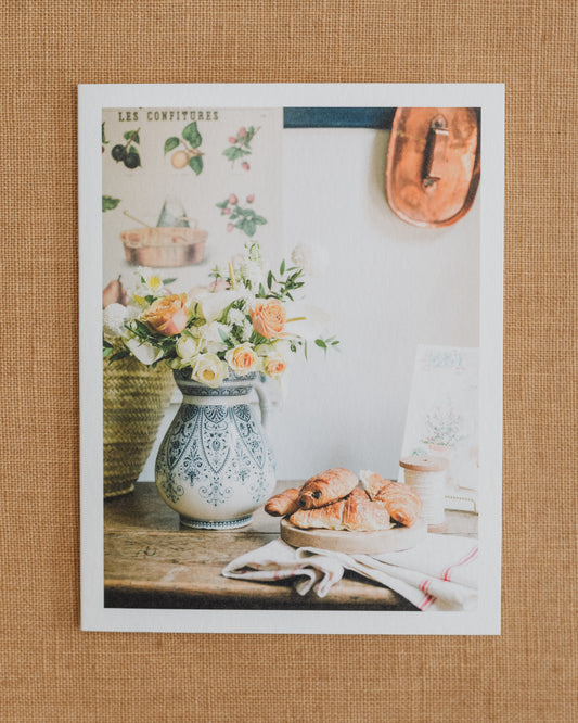 French Breakfast photographic notecard with flowers in a patterned vase and pastries on a table.