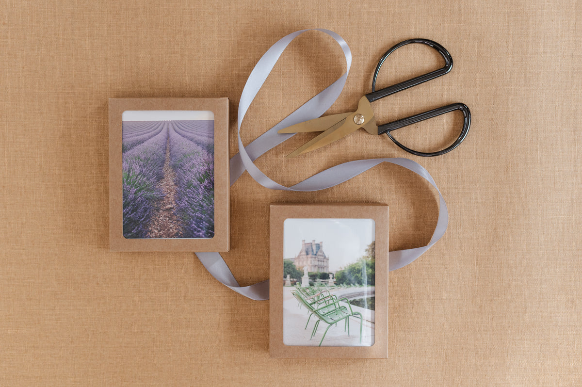 Provence and Paris notecard box sets with ribbon and scissors.